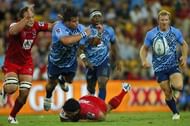 Northern Bulls' Johannes Engelbrecht gets a pass away as he is tackled by Queensland Reds' Ben Tapuai, on March 23, 2013
